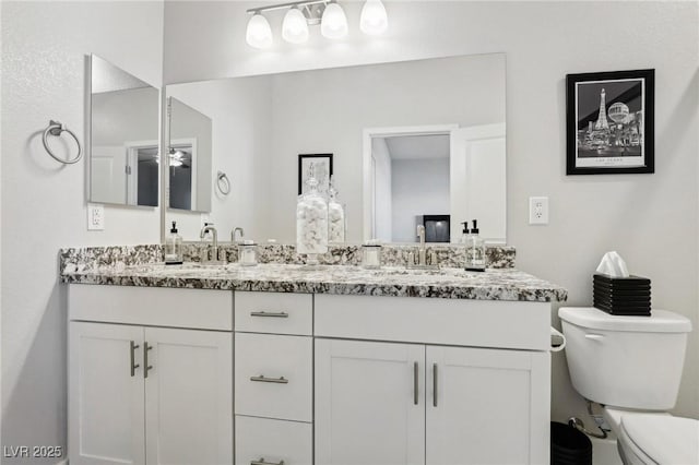 bathroom featuring toilet and vanity