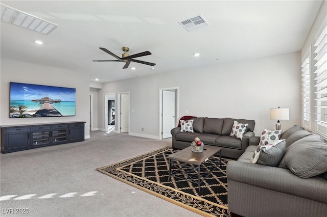 carpeted living room with ceiling fan