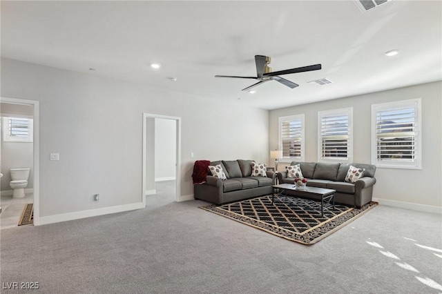 living room featuring ceiling fan and carpet