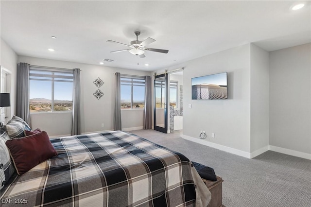 bedroom featuring ceiling fan, light carpet, and a barn door