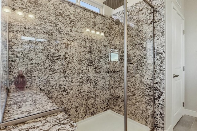 bathroom with walk in shower and tile patterned flooring