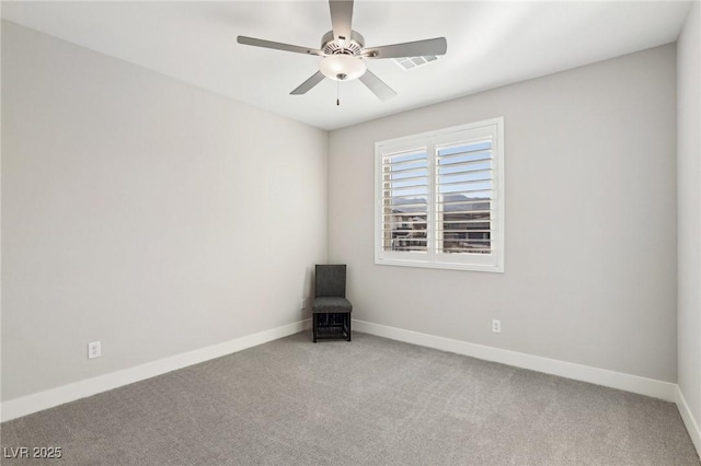 unfurnished room featuring ceiling fan and carpet