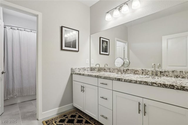 bathroom with tile patterned flooring and vanity