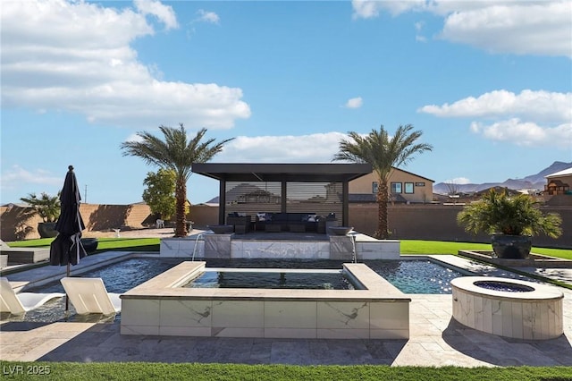 view of pool with pool water feature, a patio, and an outdoor living space with a fire pit