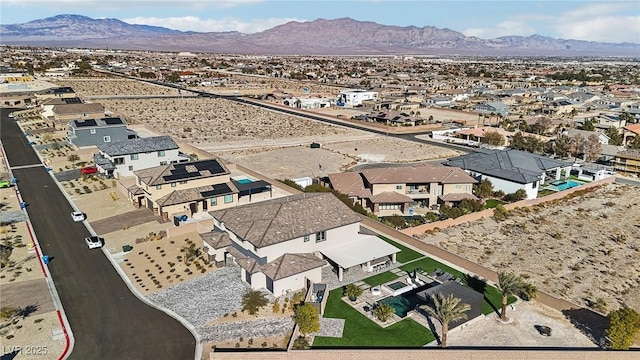 birds eye view of property with a mountain view