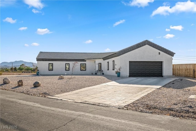 view of front of home with a garage and a mountain view