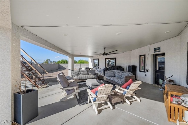 view of patio with ceiling fan and an outdoor living space