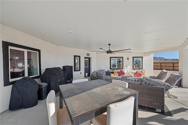 view of patio with grilling area, ceiling fan, and an outdoor living space