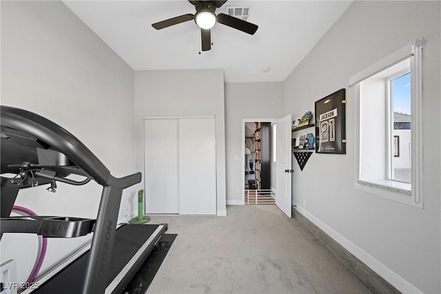 exercise room with light colored carpet, ceiling fan, and a wealth of natural light