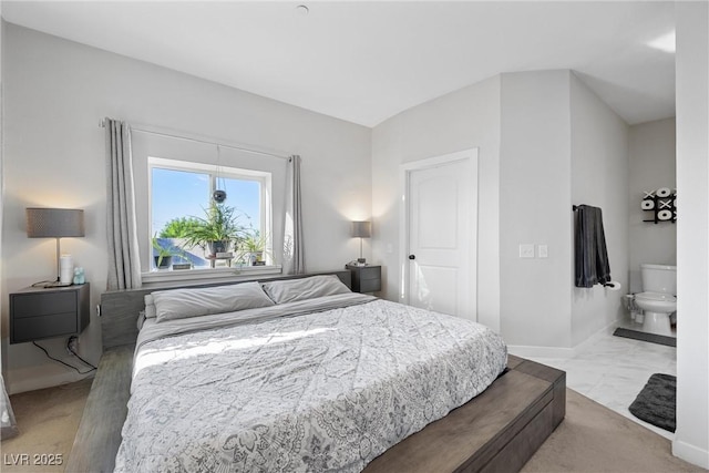 carpeted bedroom featuring connected bathroom