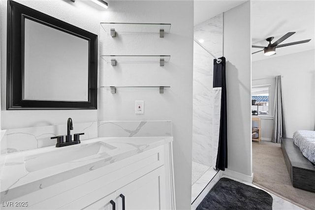 bathroom with ceiling fan, a shower, and vanity