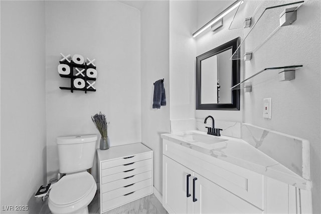 bathroom featuring toilet and vanity