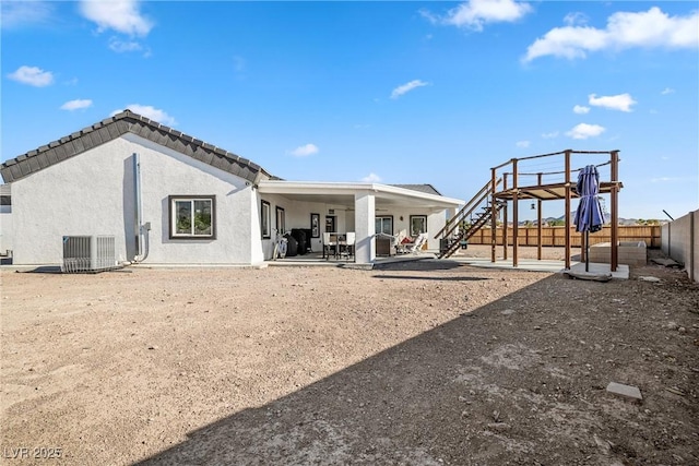 back of house with a patio and cooling unit