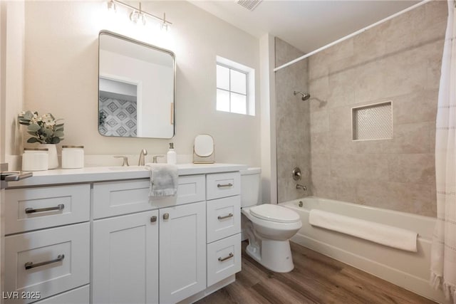 full bathroom featuring toilet, shower / tub combo, wood-type flooring, and vanity