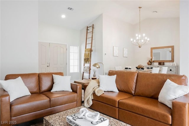 living room featuring lofted ceiling and a chandelier