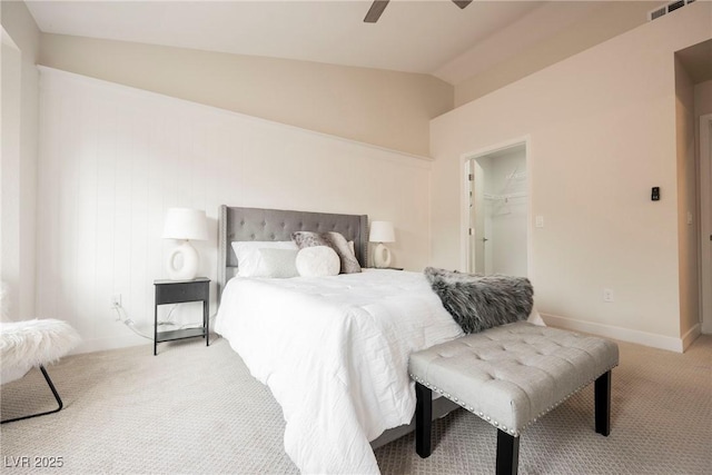 bedroom with a closet, light colored carpet, ceiling fan, a spacious closet, and lofted ceiling