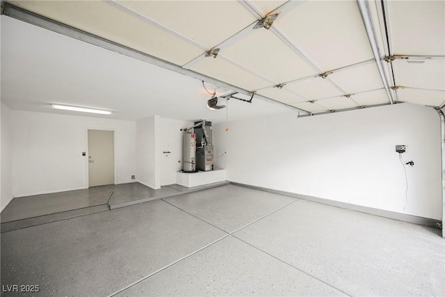 garage featuring water heater and a garage door opener