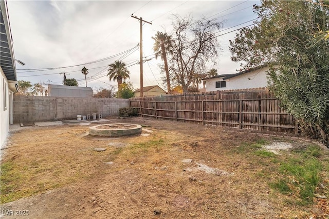 view of yard with a fire pit