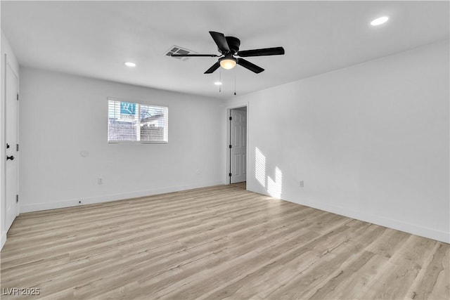 spare room featuring light wood-type flooring and ceiling fan