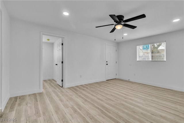 empty room with ceiling fan and light hardwood / wood-style floors