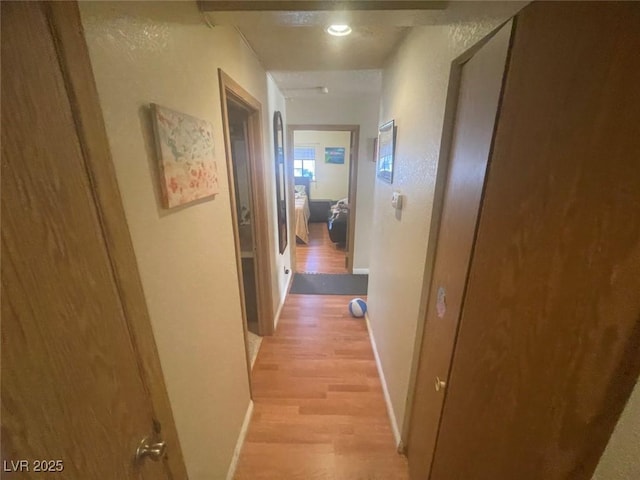 corridor with light hardwood / wood-style flooring