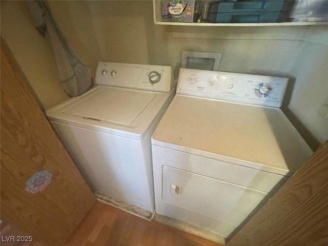 washroom with washer and dryer and hardwood / wood-style floors