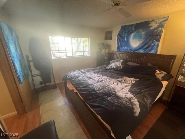 bedroom with ceiling fan and hardwood / wood-style flooring