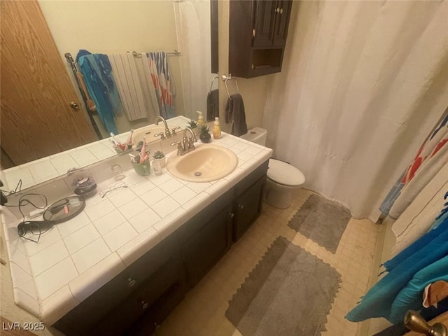 bathroom with toilet and vanity