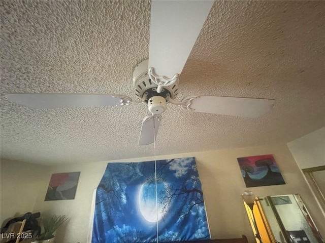 interior details featuring a textured ceiling and ceiling fan