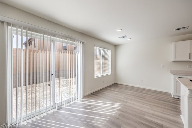 unfurnished dining area with light hardwood / wood-style flooring