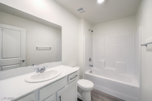 full bathroom with shower / bathing tub combination, toilet, vanity, and wood-type flooring