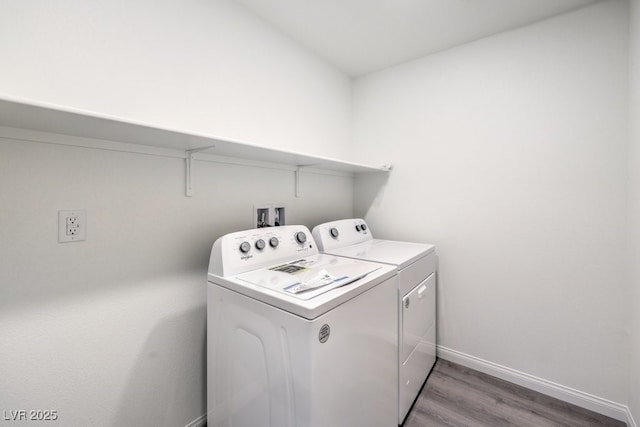 washroom featuring hardwood / wood-style floors and washing machine and dryer