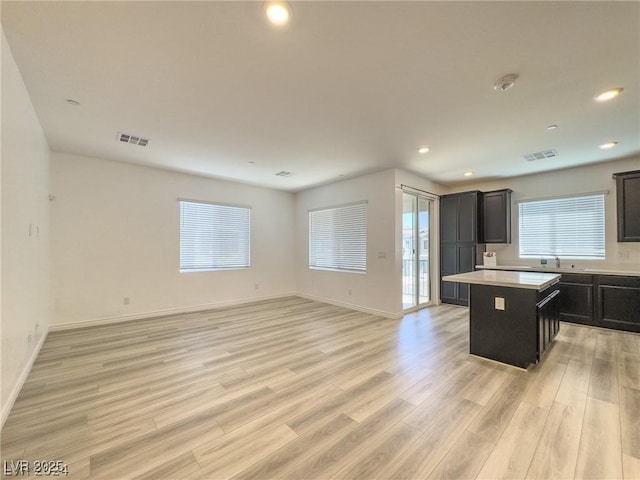 kitchen featuring a kitchen island, light hardwood / wood-style flooring, and sink