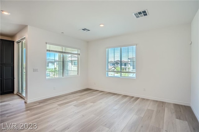 unfurnished room featuring light hardwood / wood-style floors