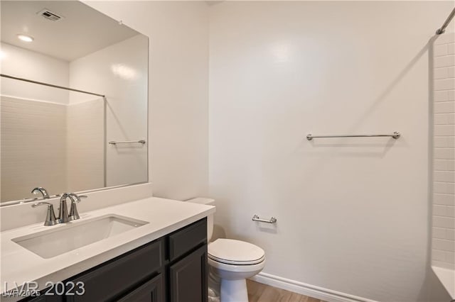 bathroom with toilet, a shower, wood-type flooring, and vanity