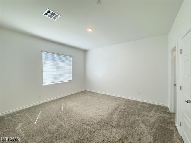 spare room featuring dark carpet