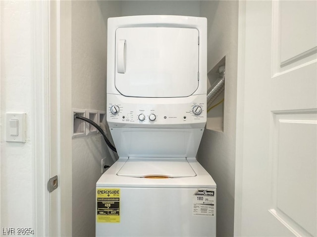 washroom with stacked washer / drying machine