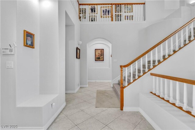 tiled foyer entrance with a high ceiling