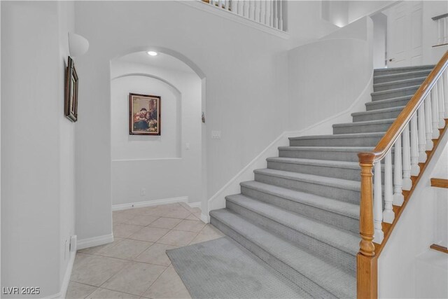 staircase with tile patterned floors