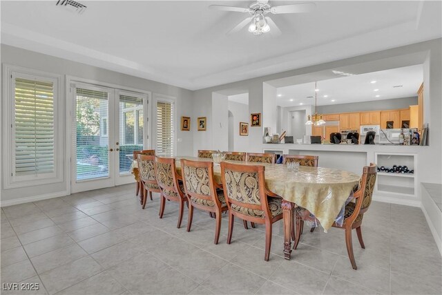 dining room featuring ceiling fan, french doors, and light tile patterned floors