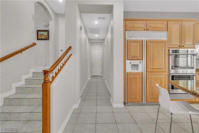 corridor featuring light tile patterned floors