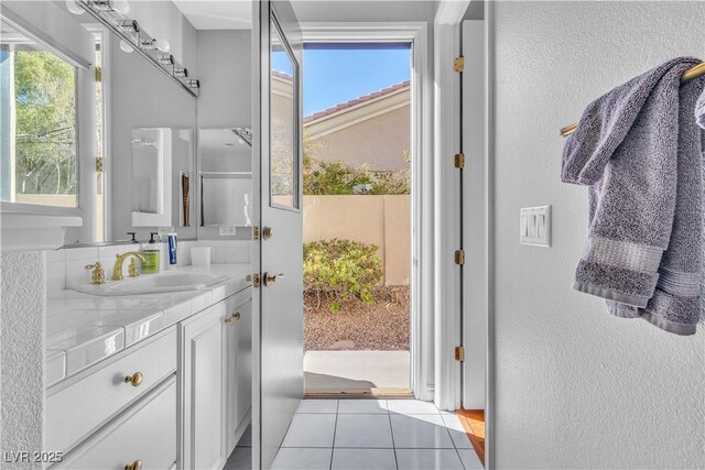 bathroom featuring tile patterned flooring and vanity