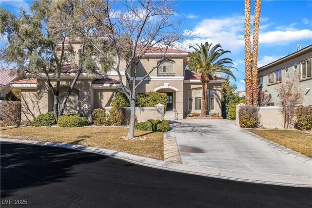 mediterranean / spanish-style home with a front lawn