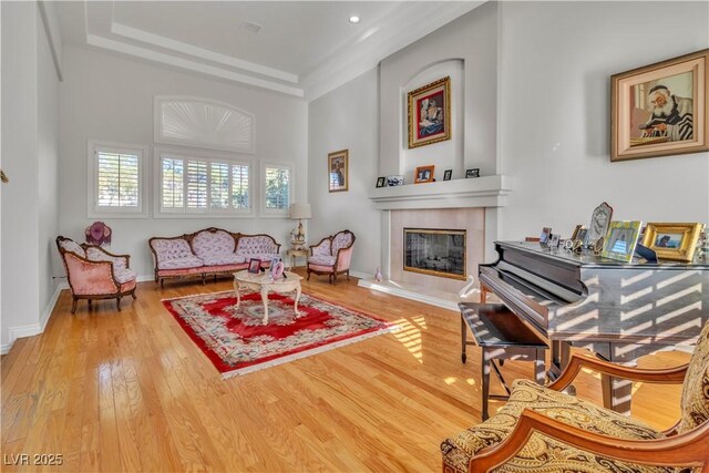 living area featuring a tiled fireplace and wood-type flooring