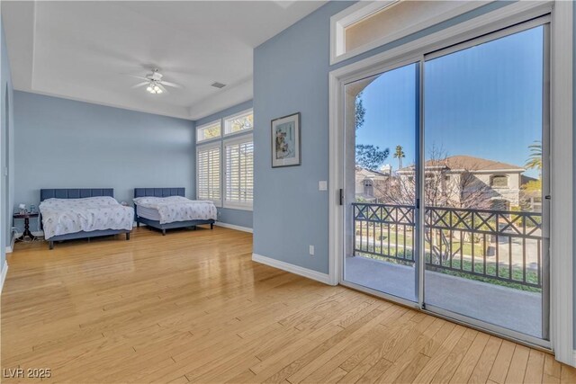 bedroom featuring access to exterior, light wood-type flooring, and ceiling fan