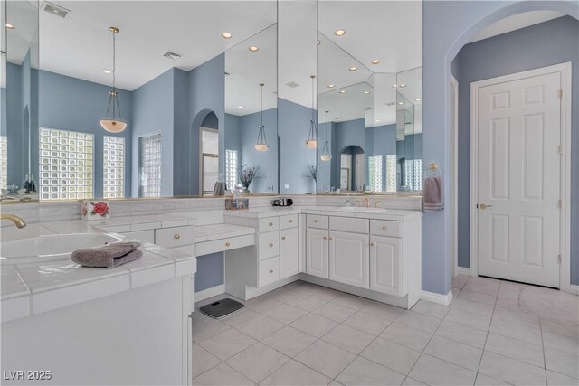 bathroom with tile patterned flooring, a wealth of natural light, and vanity