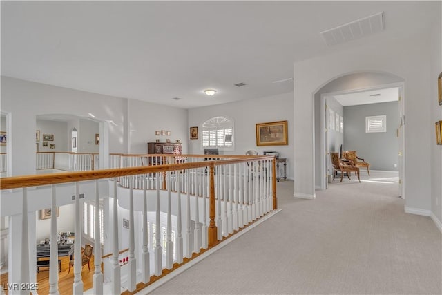 hallway with light colored carpet