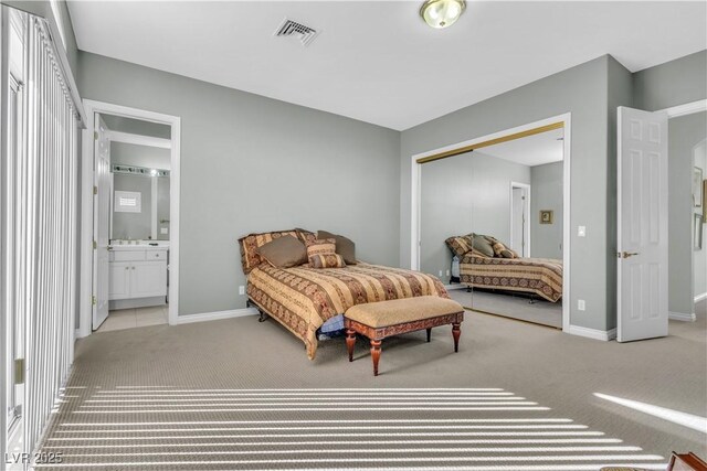 bedroom featuring a closet and light carpet