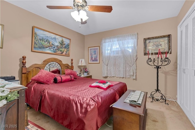 carpeted bedroom featuring ceiling fan and a closet