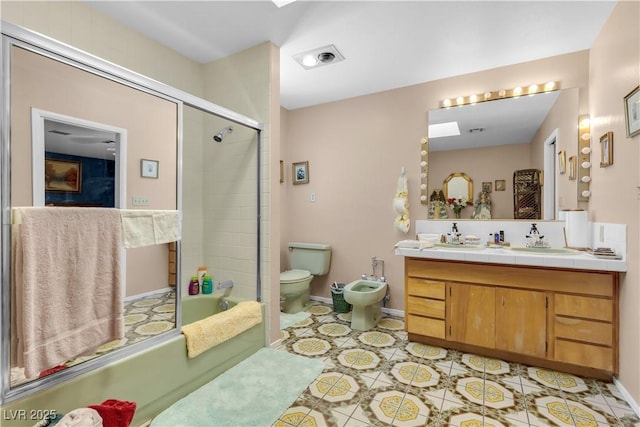 full bathroom featuring tile patterned flooring, toilet, a bidet, vanity, and shower / bath combination with glass door